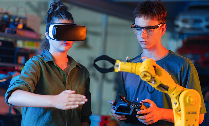 Young people doing experiments with robotics and VR headset